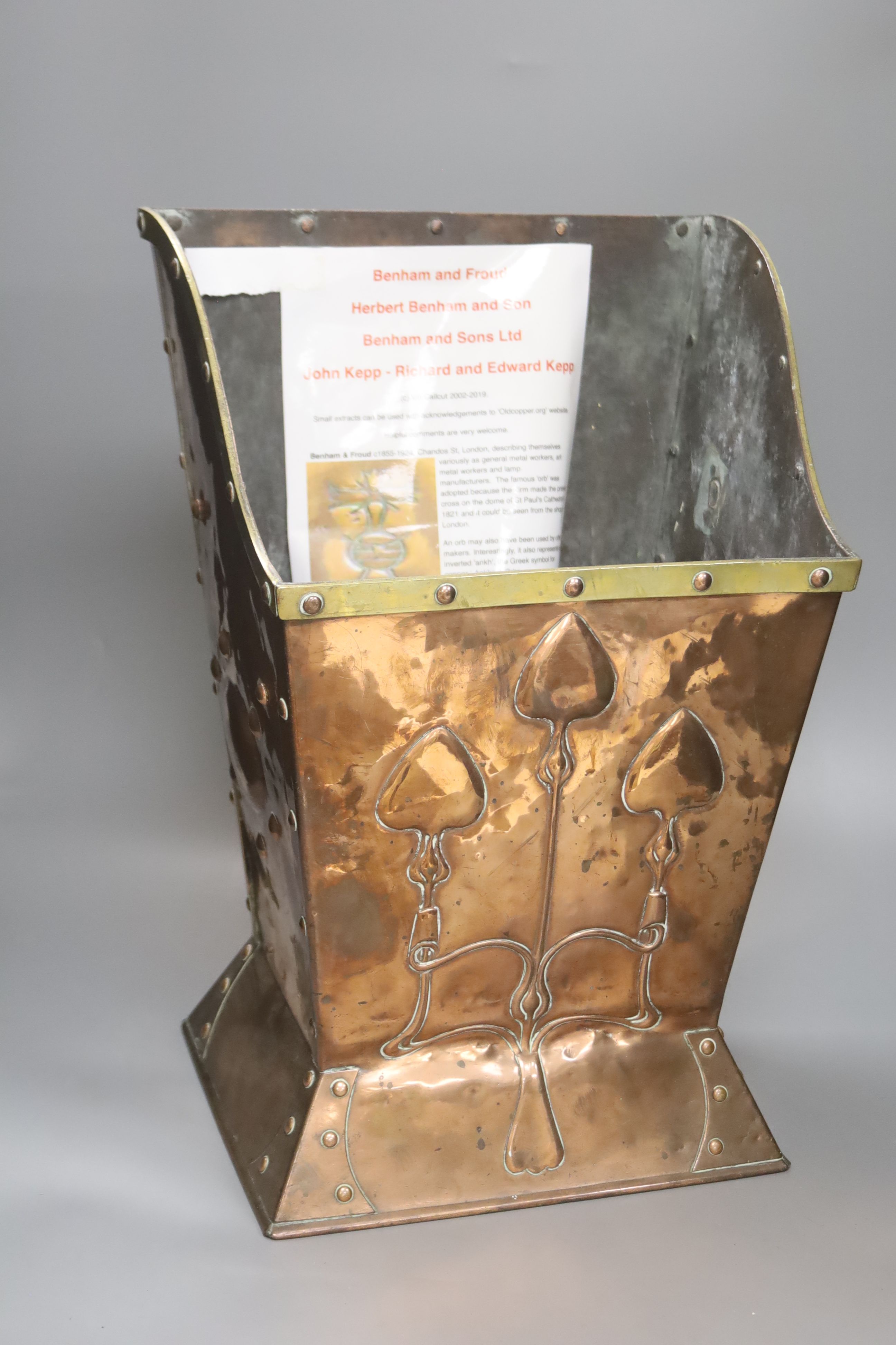 An Art Nouveau hammered copper coal box, with a brass rim